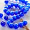 12 Packs: 34 ct. (408 total) Cobalt Blue Cat's Eye Glass Round Beads, 8mm by Bead Landing™
